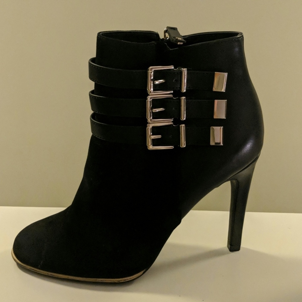 Black heeled booties with buckle details